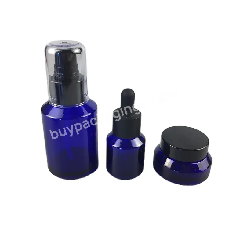 100ml Empty Glass Bottle Cobalt Blue Bottle With Cream Pump And Transparent Over Cap For Cosmetic Cream