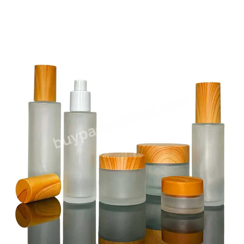 A Set Of Frosted Clear Frosted Personal Skin Care Glass Dropper Bottles And Glass Jar With Bamboo Lid