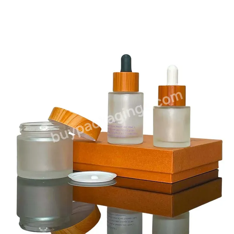 A Set Of Frosted Clear Frosted Personal Skin Care Glass Dropper Bottles And Glass Jar With Bamboo Lid