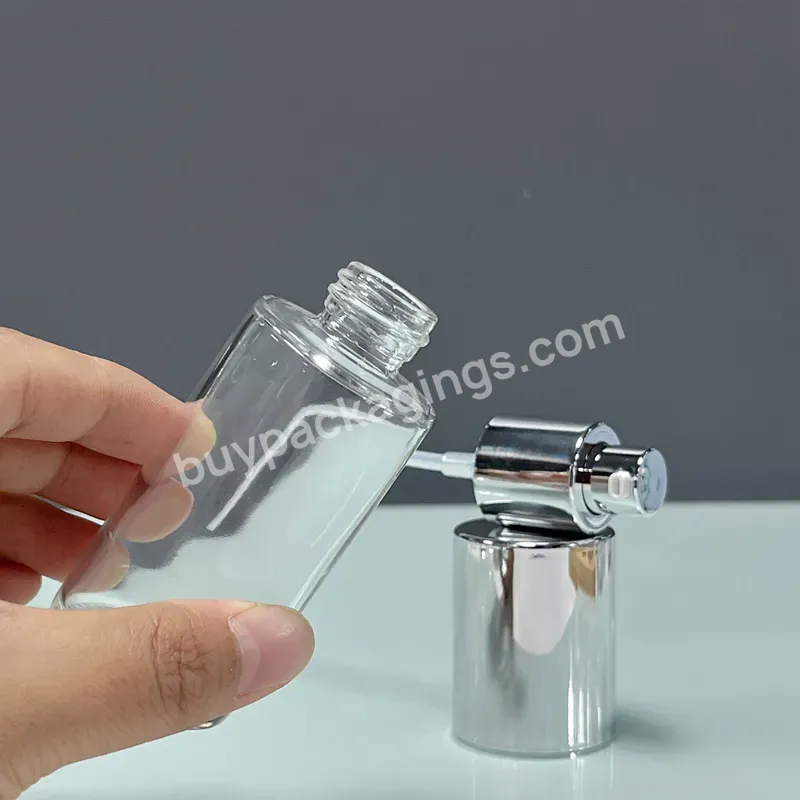 Wholesale Cosmetic Packaging Empty Glass Liquid Foundation Round 50ml Clear Glass Bottle With Silver Pump Cap