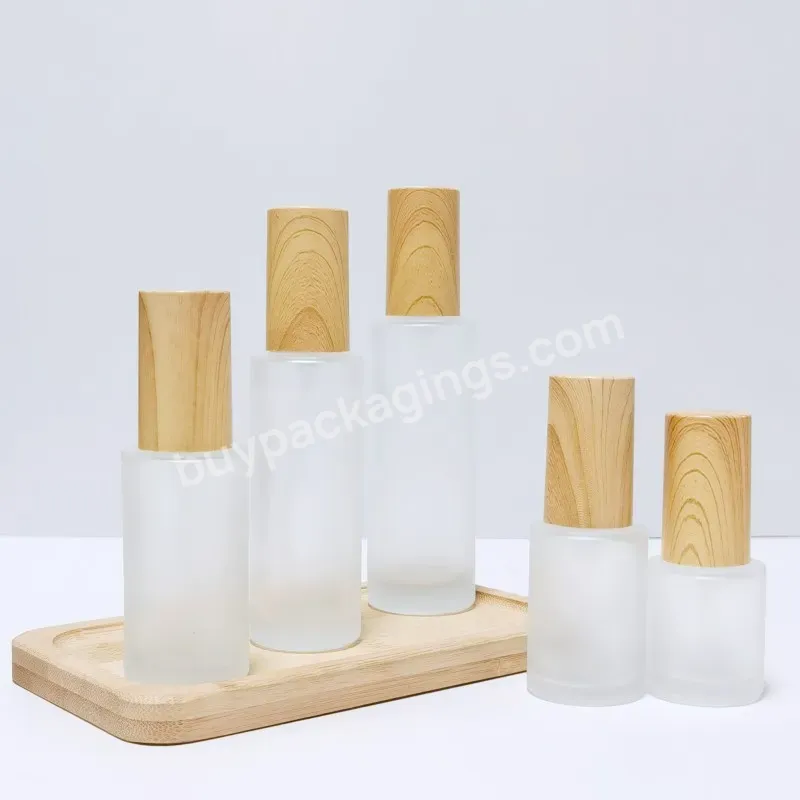 Wholesale Cosmetic Packaging Skin Care Set Frosted Lotion Glass Bottles With Wooden Plastic Lid Cosmetic