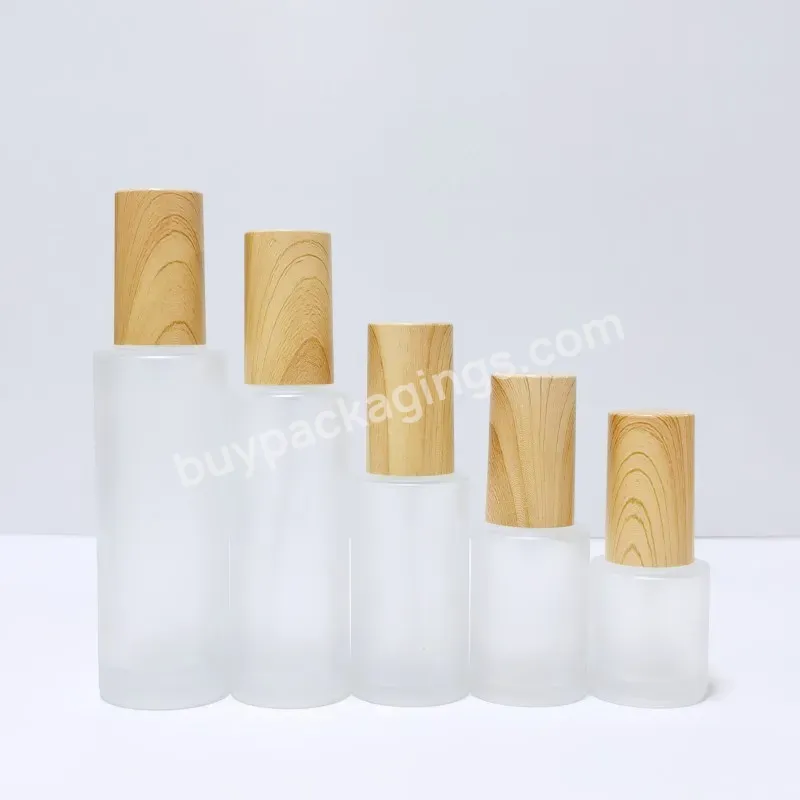 Wholesale Cosmetic Packaging Skin Care Set Frosted Lotion Glass Bottles With Wooden Plastic Lid Cosmetic